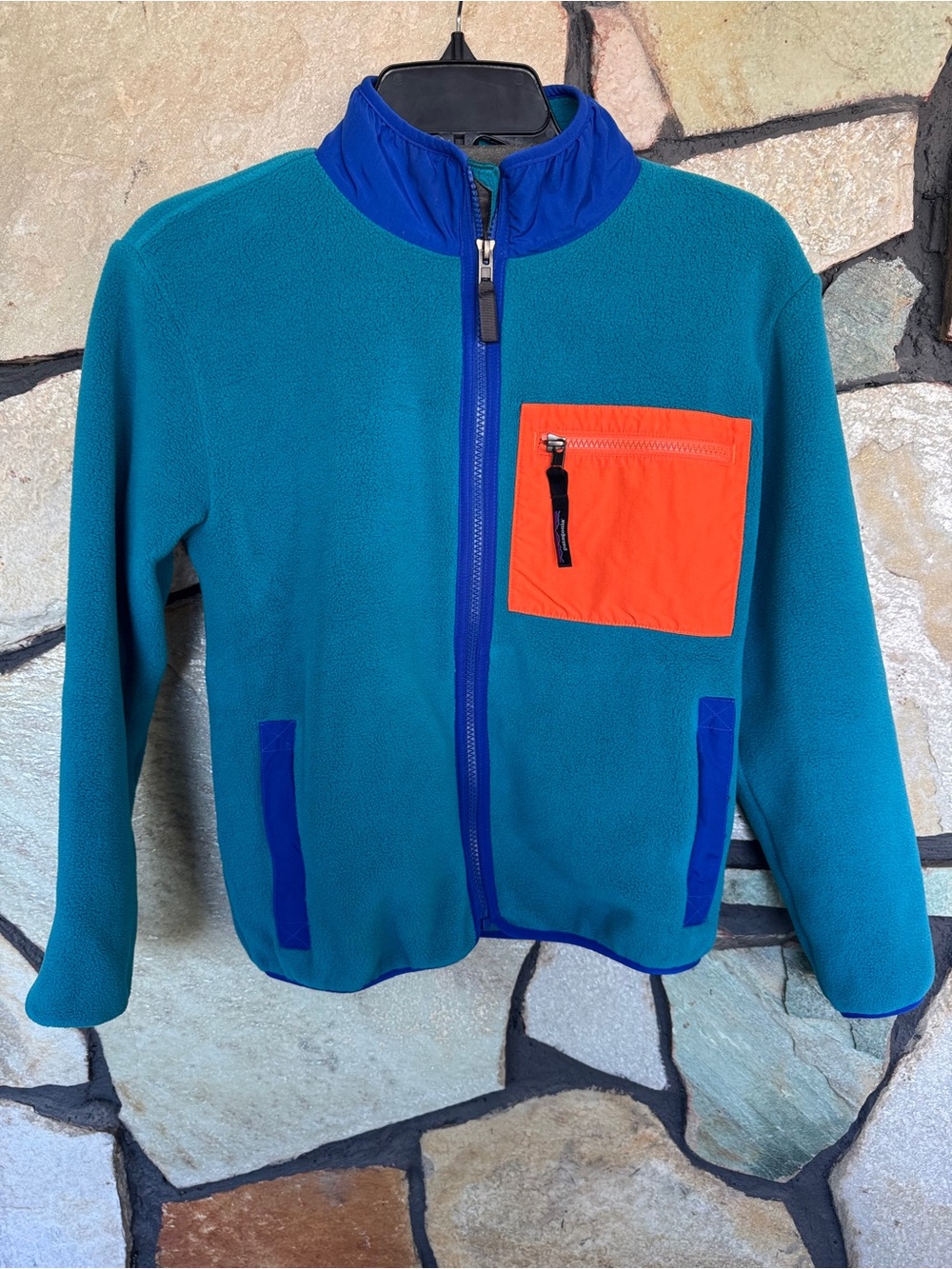 Patagonia Teal Fleece Jacket with Orange Chest Pocket and Blue Trim Accents